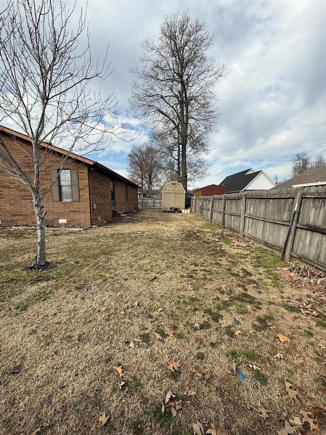 view of yard with fence and an outdoor structure