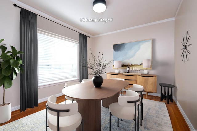 dining space with crown molding, baseboards, and wood finished floors