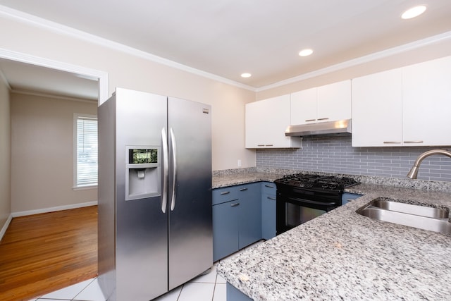 kitchen with stainless steel refrigerator with ice dispenser, ornamental molding, black gas stove, a sink, and under cabinet range hood