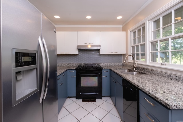 kitchen with blue cabinetry, a sink, under cabinet range hood, and black appliances