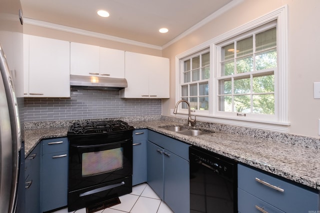 kitchen featuring black appliances, blue cabinetry, a sink, and under cabinet range hood