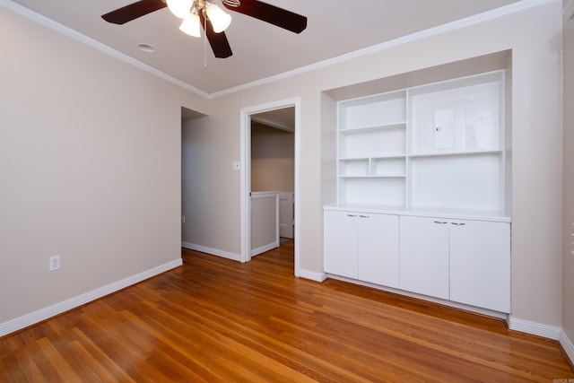 unfurnished bedroom with ornamental molding, light wood-style flooring, and baseboards