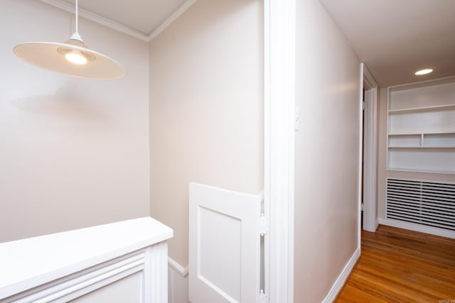 hallway featuring recessed lighting, crown molding, and light wood finished floors