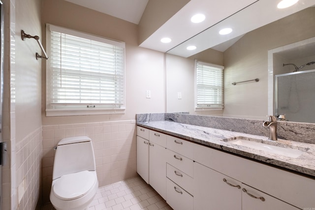 full bathroom featuring tile patterned floors, vanity, a shower stall, tile walls, and recessed lighting