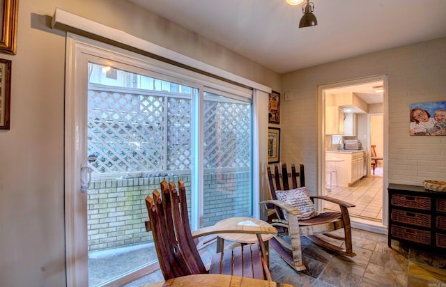 living area featuring brick wall