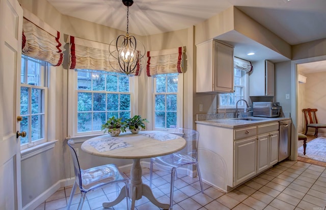 kitchen featuring a chandelier, a healthy amount of sunlight, light countertops, and a sink