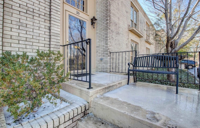 exterior space with a gate and brick siding