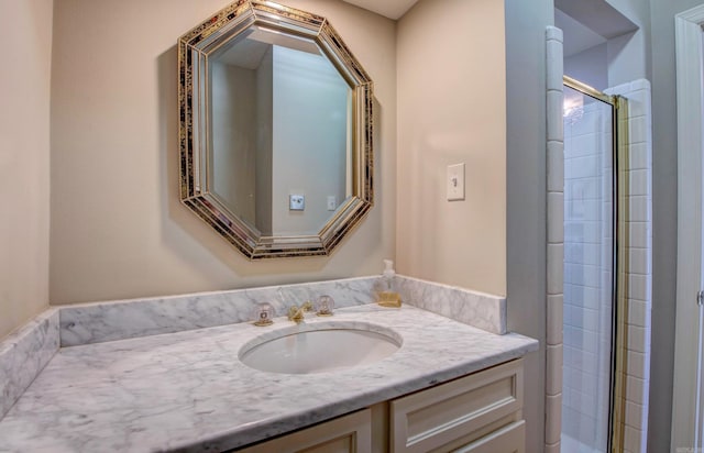bathroom featuring tiled shower and vanity