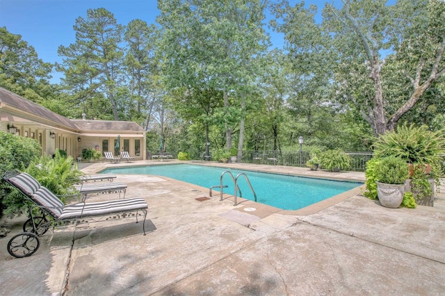 pool featuring a patio and fence