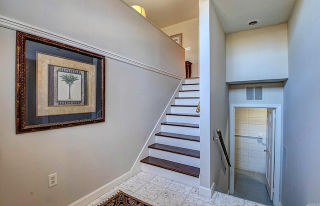 stairs with baseboards and visible vents