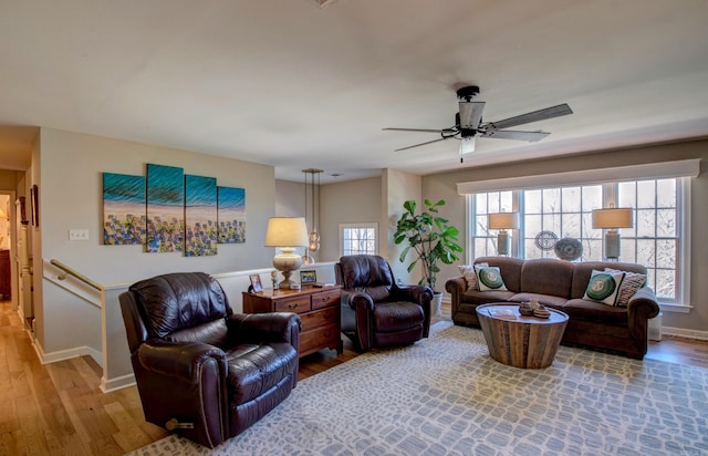 living room with ceiling fan, wood finished floors, and baseboards