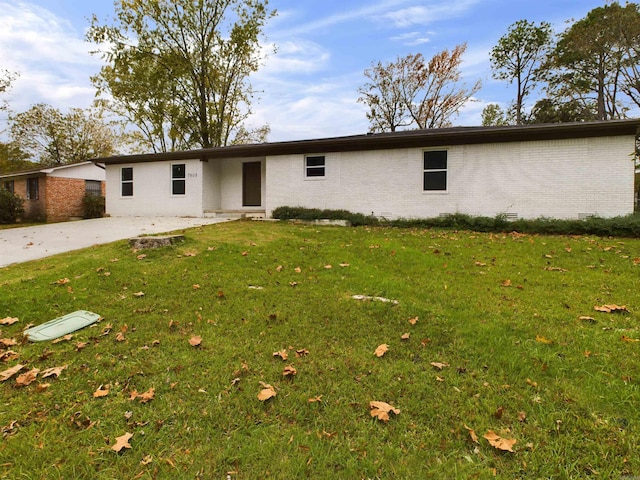 view of front of house featuring a front yard, crawl space, and brick siding