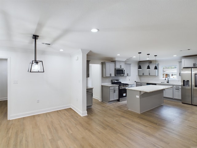 kitchen featuring visible vents, light wood-style flooring, a kitchen island, appliances with stainless steel finishes, and gray cabinets