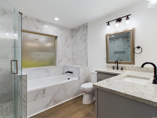 full bath with a marble finish shower, toilet, vanity, wood finished floors, and a bath