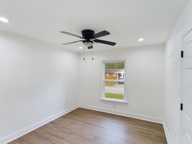 spare room featuring a ceiling fan, baseboards, wood finished floors, and recessed lighting