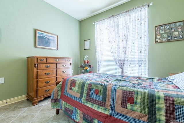 bedroom featuring baseboards and light tile patterned flooring