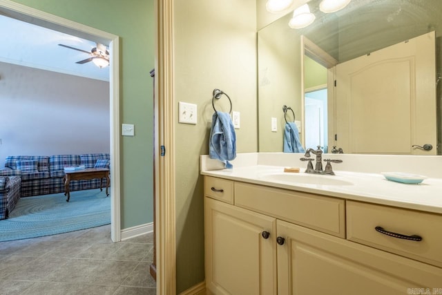 bathroom featuring tile patterned flooring, baseboards, a ceiling fan, and vanity