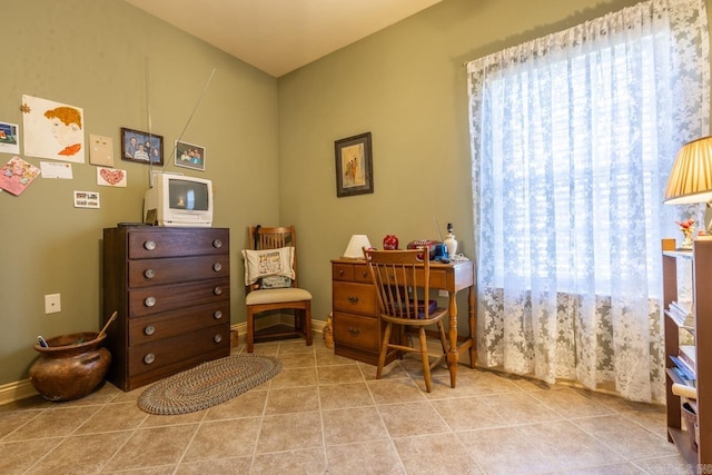 living area featuring tile patterned flooring and baseboards