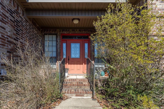 view of exterior entry with brick siding