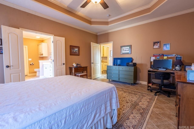 tiled bedroom with crown molding, a raised ceiling, connected bathroom, ceiling fan, and baseboards