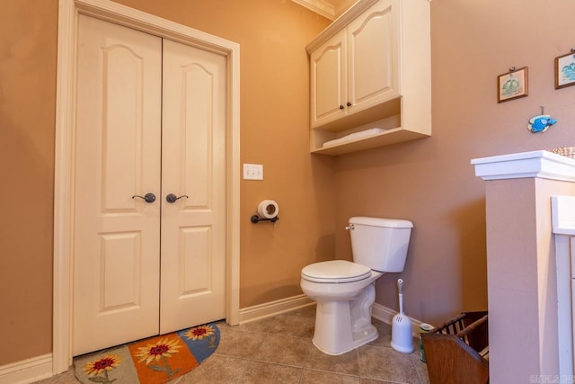 bathroom featuring baseboards, toilet, and tile patterned floors