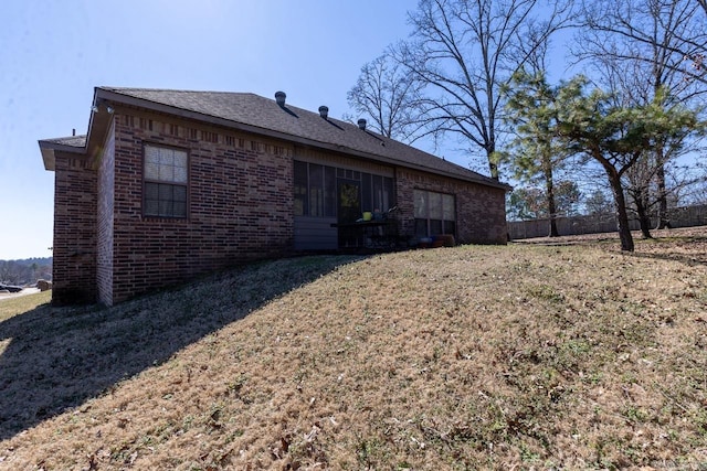 exterior space featuring a yard and brick siding