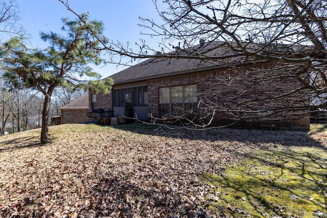 back of property featuring brick siding