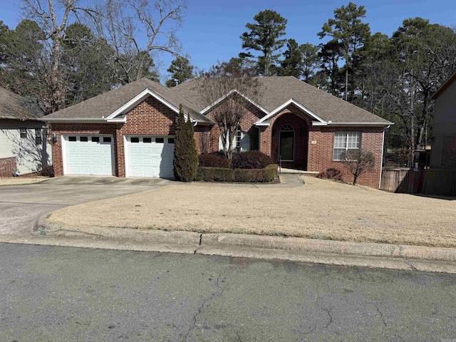 ranch-style home featuring a garage, driveway, brick siding, and roof with shingles