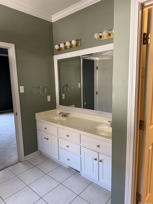 full bath with double vanity, tile patterned flooring, crown molding, and a sink