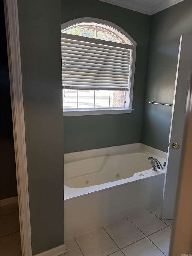 full bath featuring a whirlpool tub, ornamental molding, and tile patterned flooring