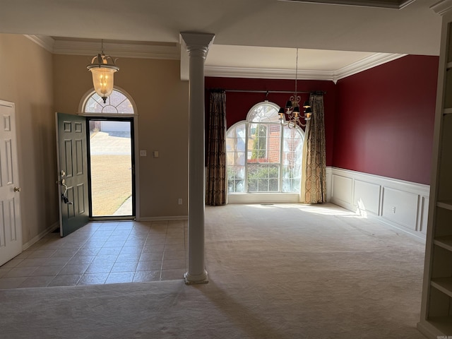 entrance foyer featuring carpet, a healthy amount of sunlight, and decorative columns