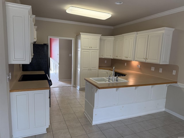 kitchen with a breakfast bar area, ornamental molding, light tile patterned flooring, a sink, and a peninsula