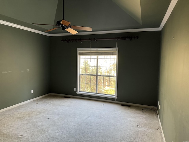 spare room with carpet floors, crown molding, baseboards, and ceiling fan