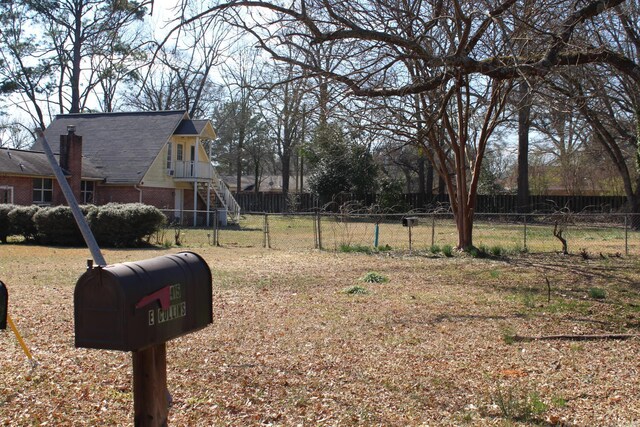view of yard with stairway and fence