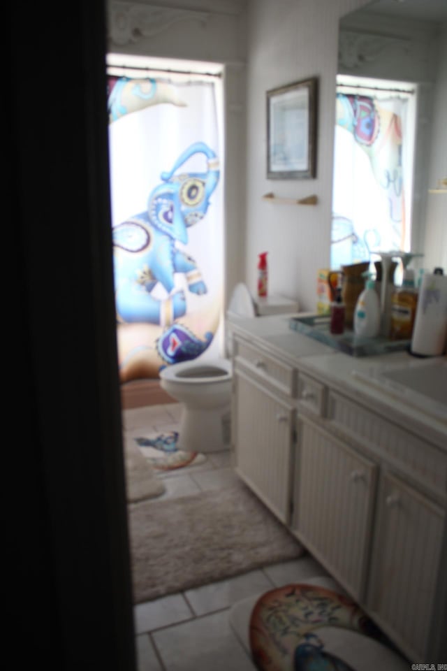 bathroom featuring vanity, tile patterned floors, toilet, and a healthy amount of sunlight