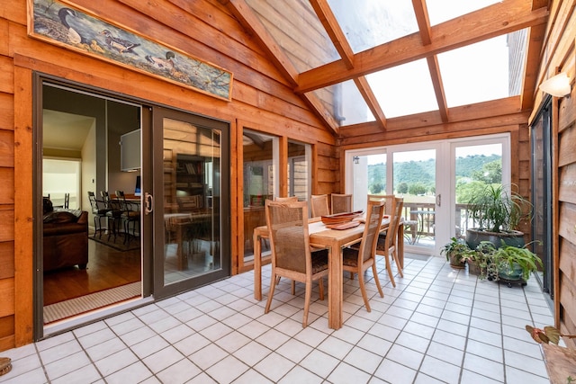 sunroom featuring lofted ceiling with beams