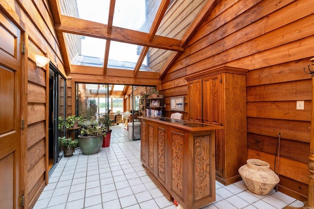 interior space with vaulted ceiling with skylight