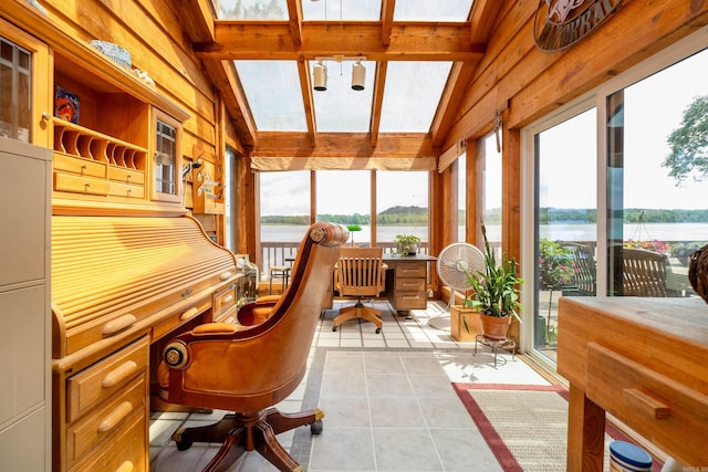 sunroom featuring lofted ceiling, a water view, and built in desk