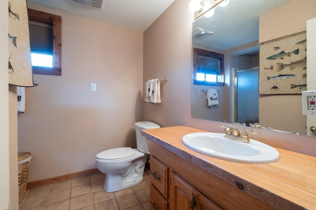 bathroom with baseboards, toilet, a shower with door, tile patterned floors, and vanity