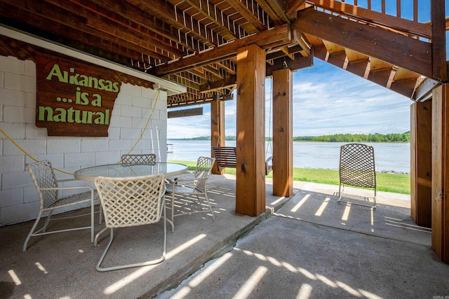 view of patio / terrace with a water view and outdoor dining area