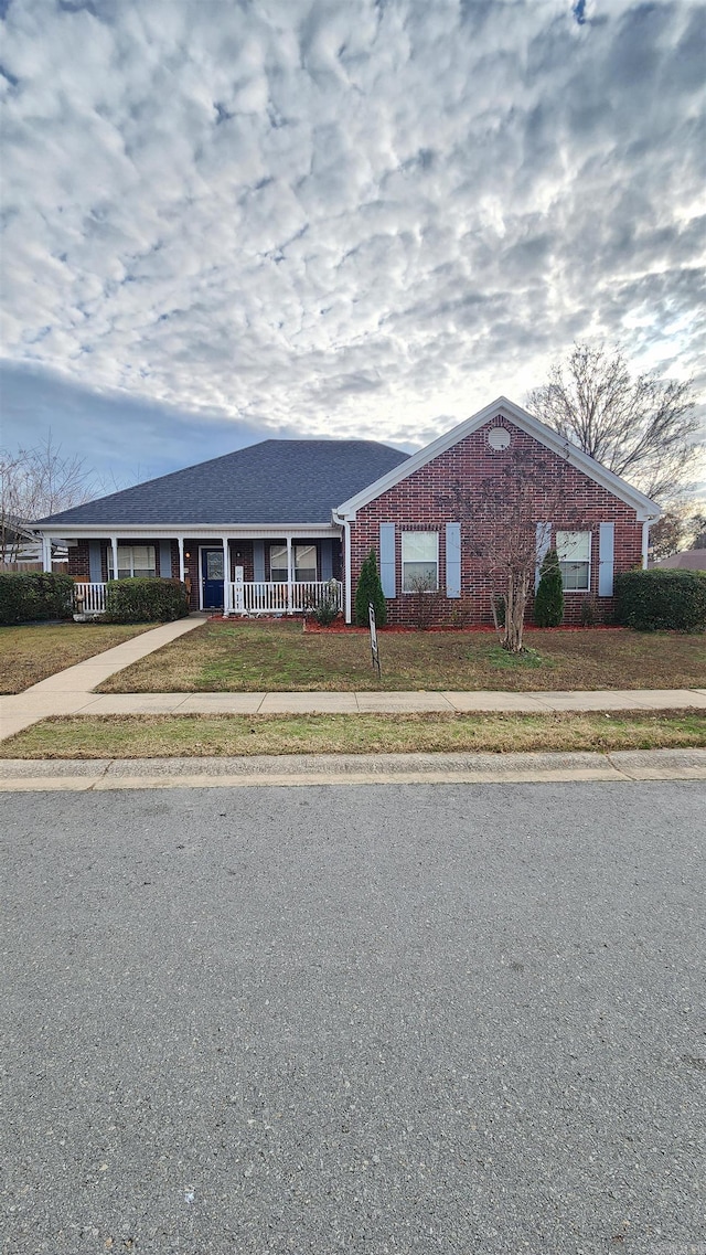 ranch-style house with brick siding and a front lawn