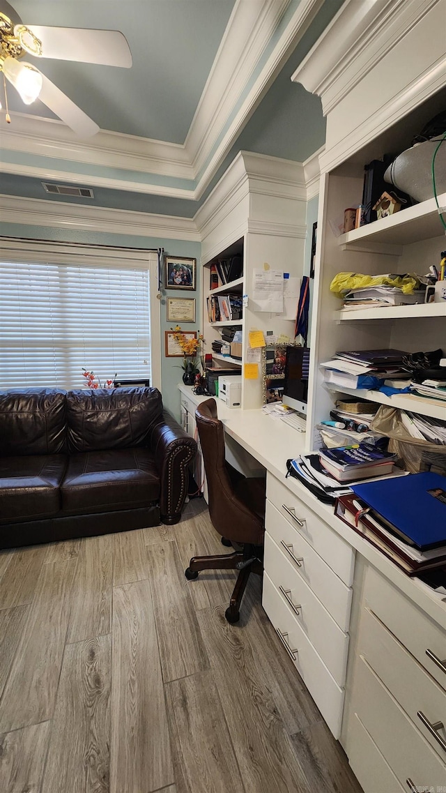 office space with a ceiling fan, visible vents, crown molding, and wood finished floors