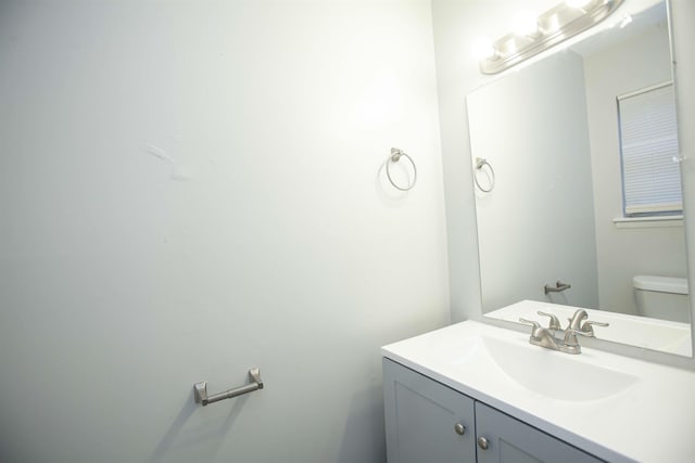 half bathroom featuring toilet and vanity