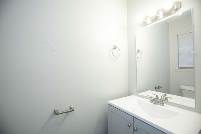 bathroom featuring toilet and vanity