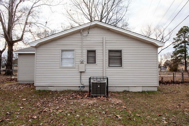 back of house with crawl space, fence, and central AC unit