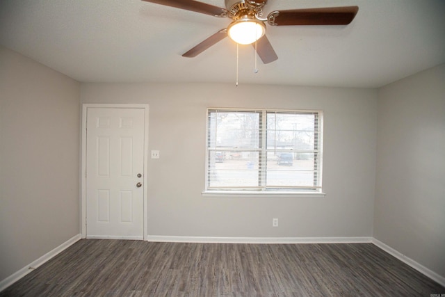 spare room with a ceiling fan, baseboards, and wood finished floors