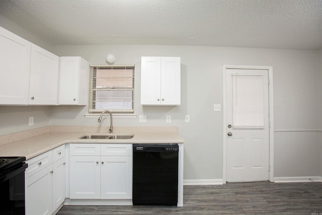 kitchen with dark wood-type flooring, a sink, white cabinets, light countertops, and black appliances