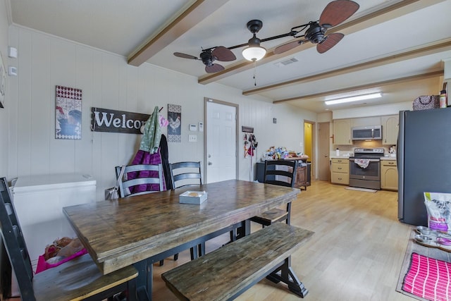 dining space with light wood-style flooring, beamed ceiling, and visible vents