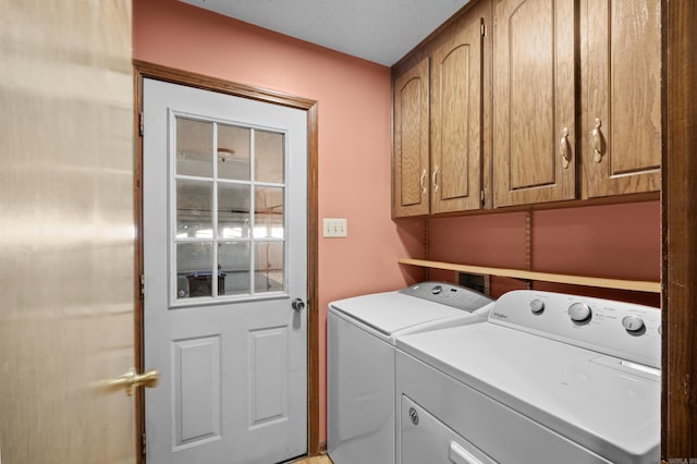 clothes washing area with cabinet space and washer and dryer