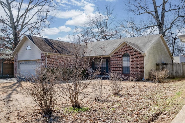 single story home with a garage, brick siding, and fence